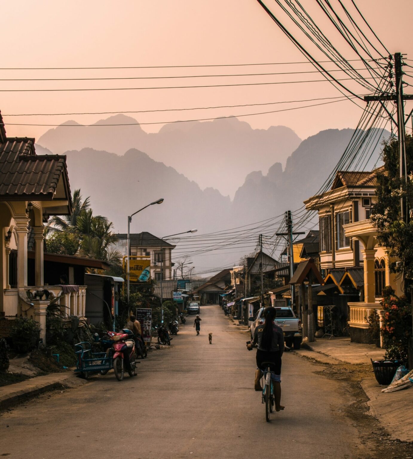 Vang Vieng, Laos street with bike and mountains