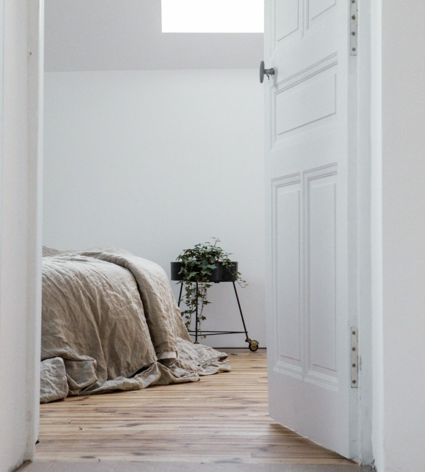 Bed with white walls and skylight