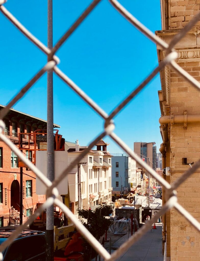 City scape seen through chainlink fence