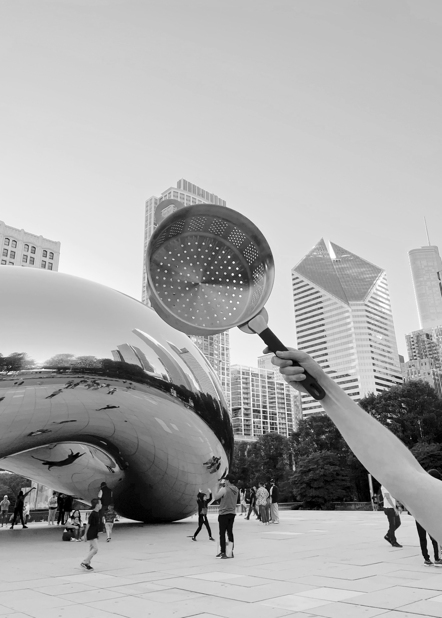 Hand holding Stackware Steamer in front of Chicago bean cloud gate statue