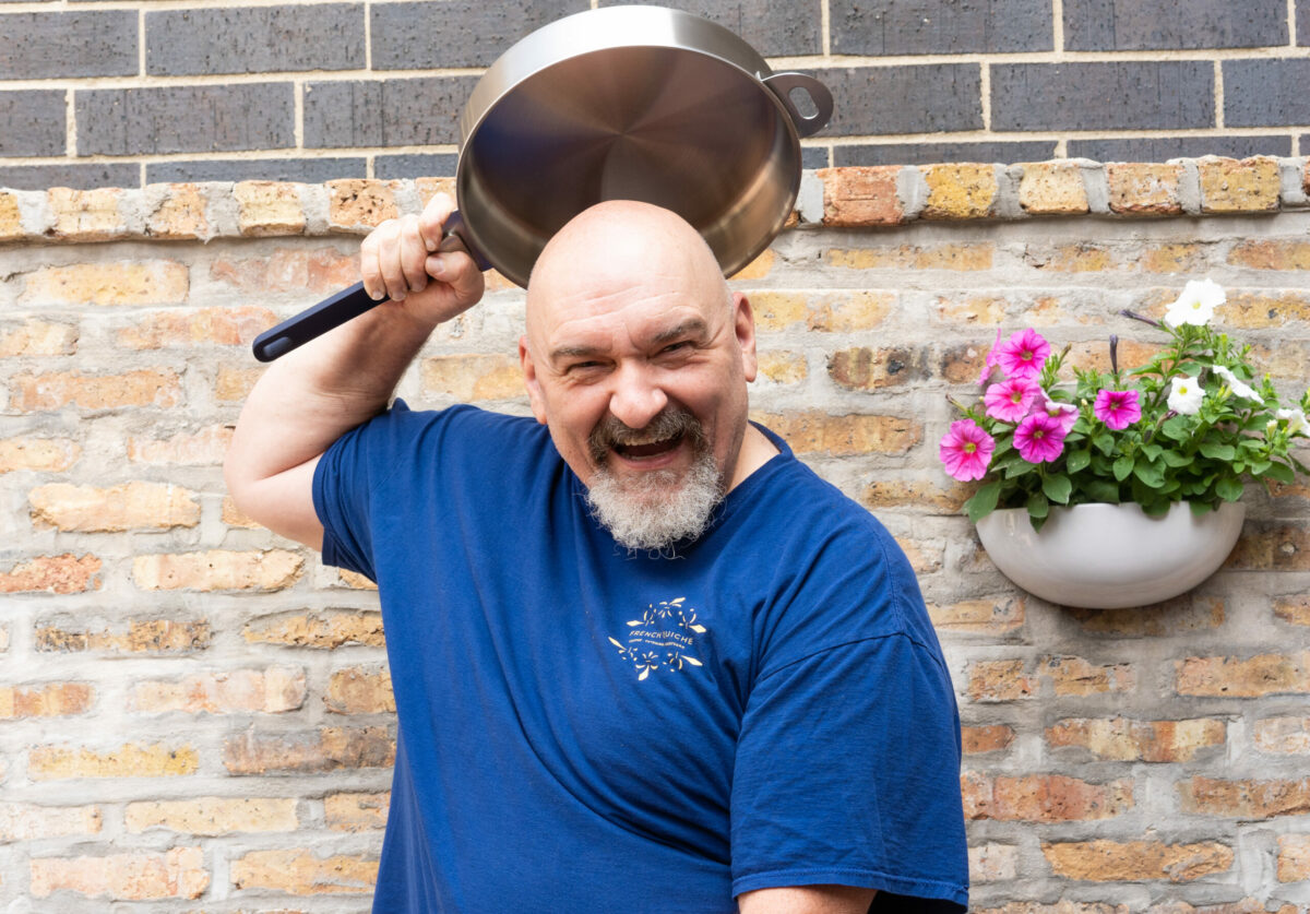 Dominique Tougne Holding Stackware over head