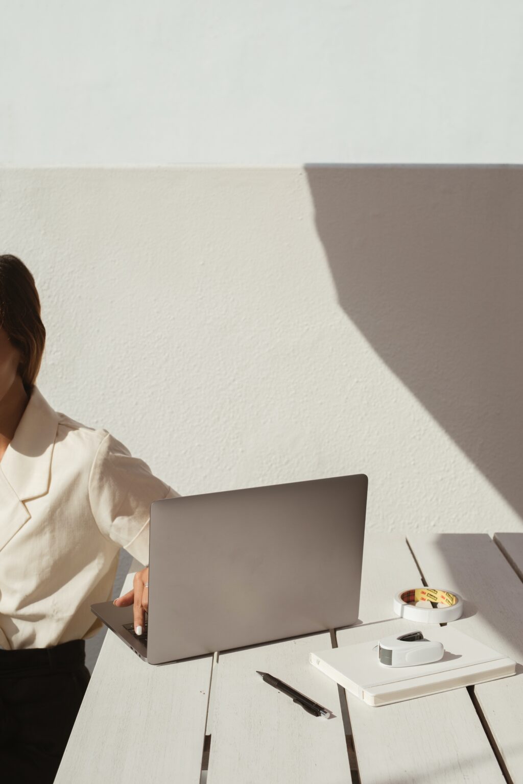 business woman with laptop at white picnic table