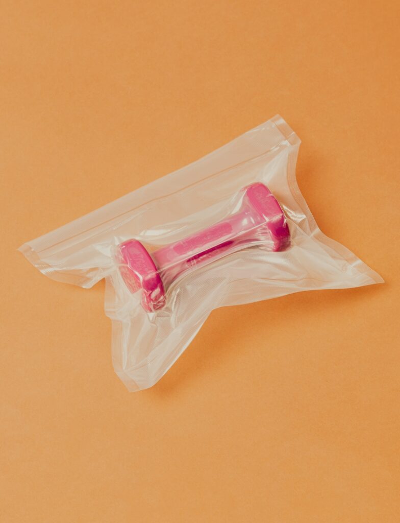 Pink dumbell wrapped in plastic