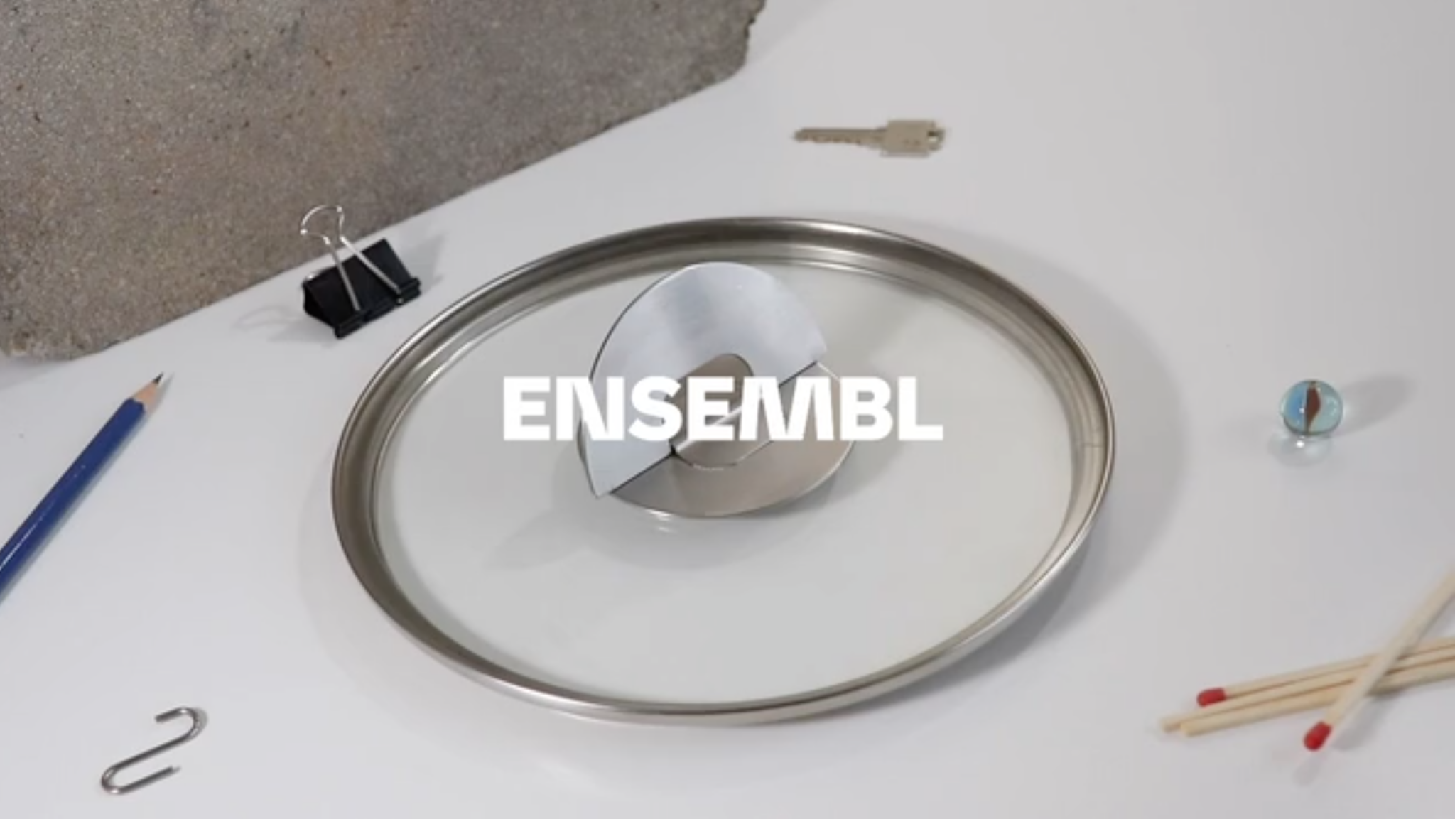 Clear glass cookware lid with ENSEMBL logo